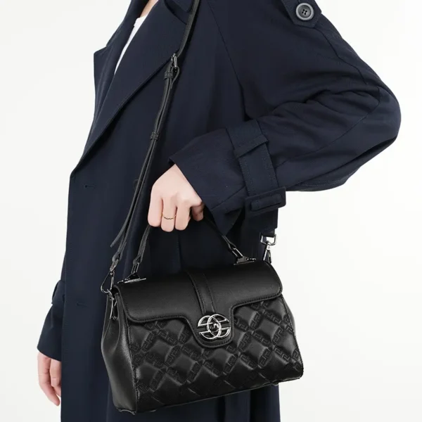 Black leather satchel handbag with top handle, trendy and elegant for work or school