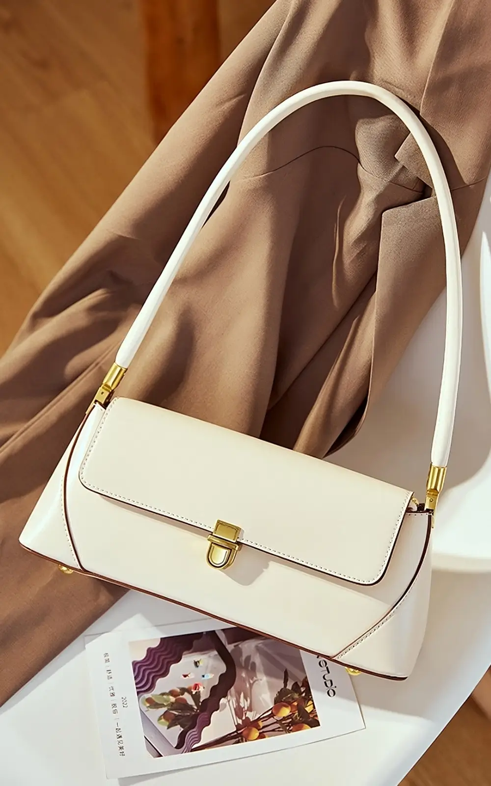 White premium handbag with gold hardware and rectangular silhouette