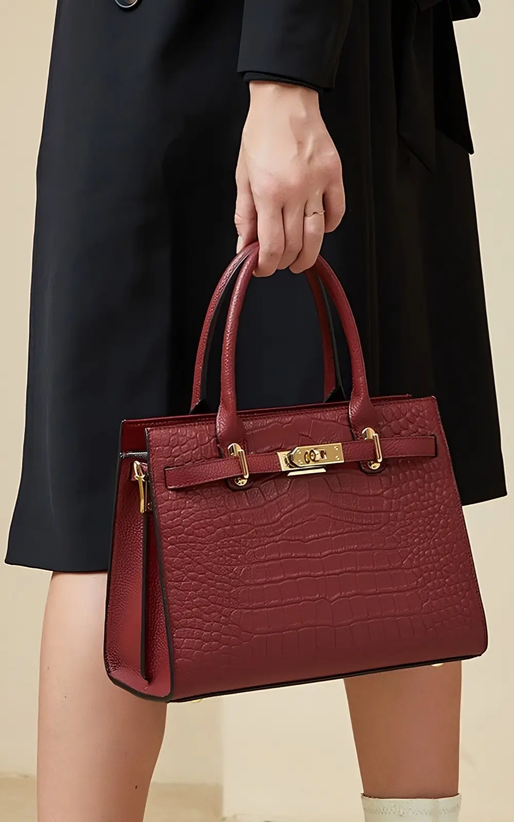 Red structured satchel bag with top handle and gold hardware