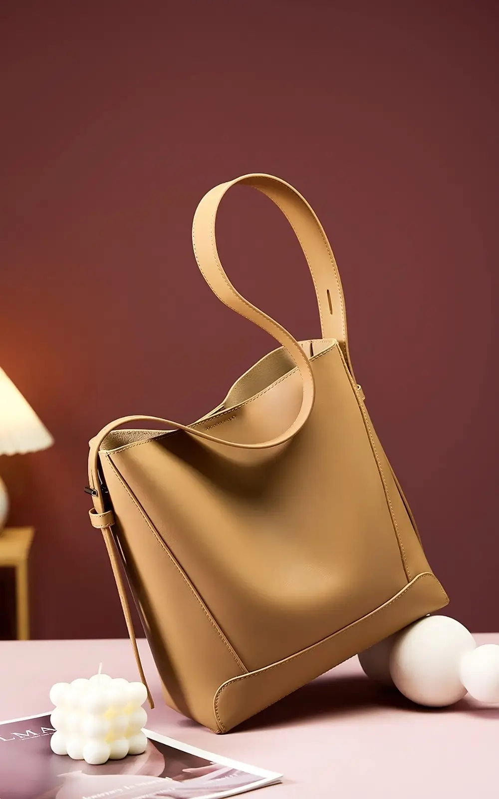 Side view of Lunaro Bucket structured leather bucket bag in light brown
