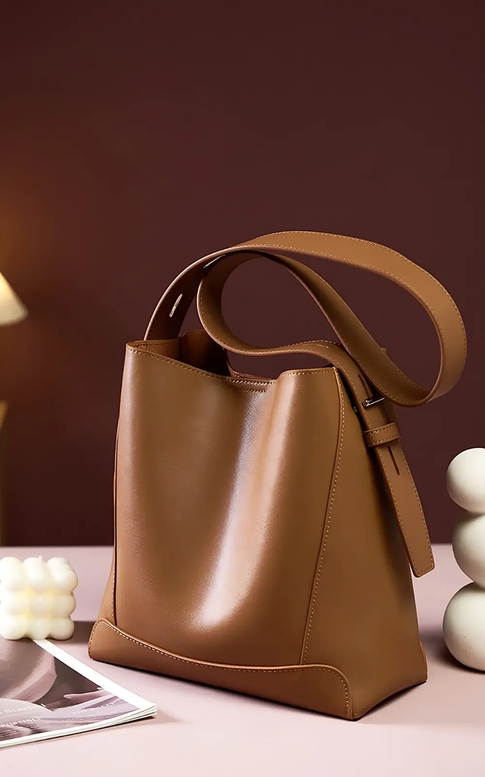 Brown Lunaro Bucket bag on café table with gold hardware visible