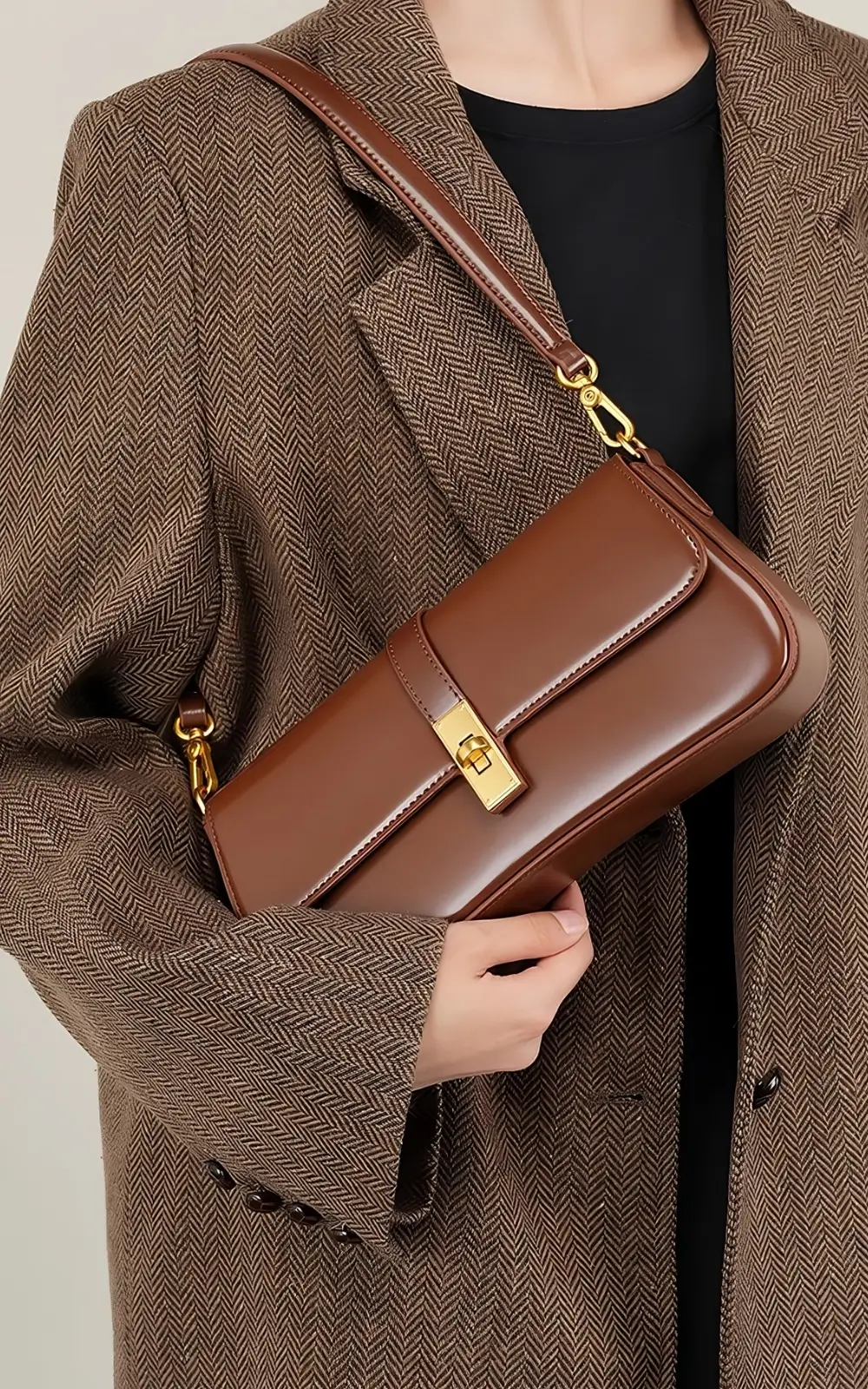 Sleek brown Marisse Baguette Bag hanging from adjustable shoulder strap