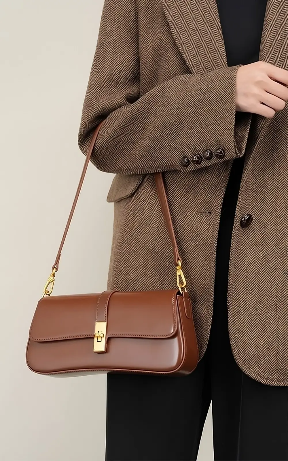 Brown Marisse Baguette Bag on a wooden surface with natural light accentuating leather tone