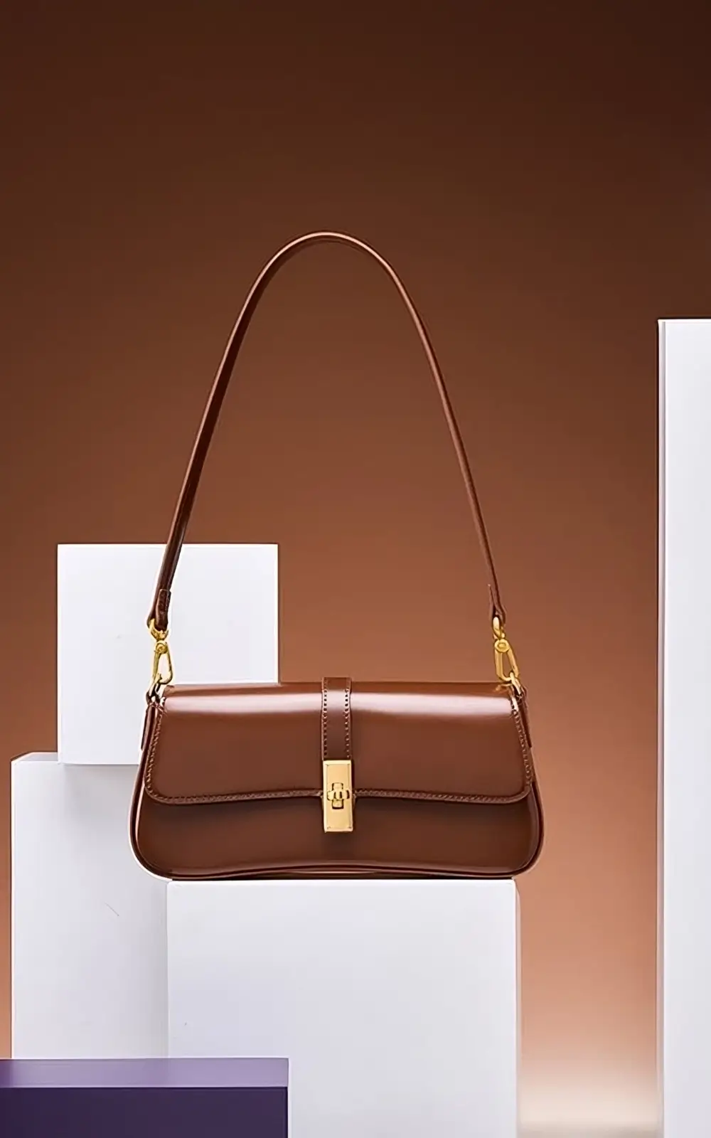 Side angle of brown Marisse Baguette Bag highlighting strap and sleek silhouette