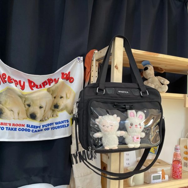 Black Ita Bag Hanging on Wooden Rack with Plush Display | Hoclin