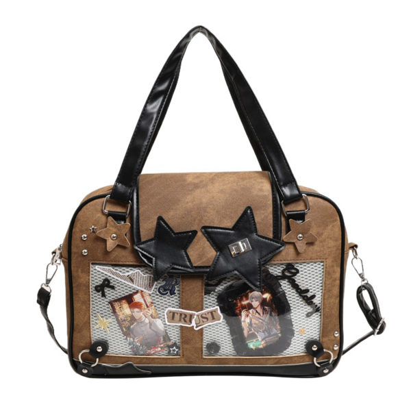 Front view of brown denim ita bag with black cat face and star studs on a white background