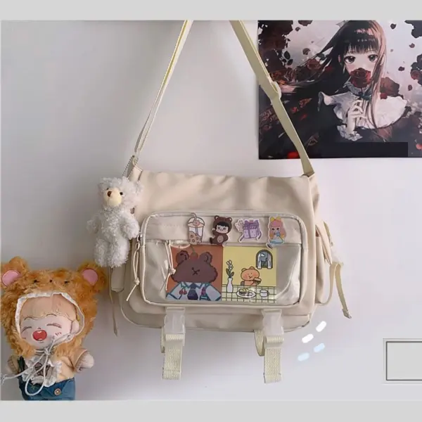 Cream ita bag with white plush bear attached to side strap