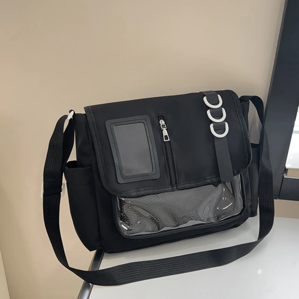 Close up of side mesh pocket and metal D-ring on black ita bag