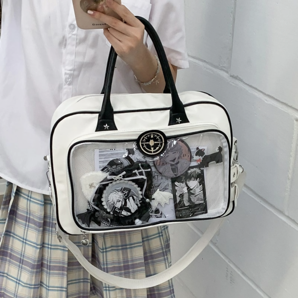 White crossbody ita bag worn by a person in casual streetwear