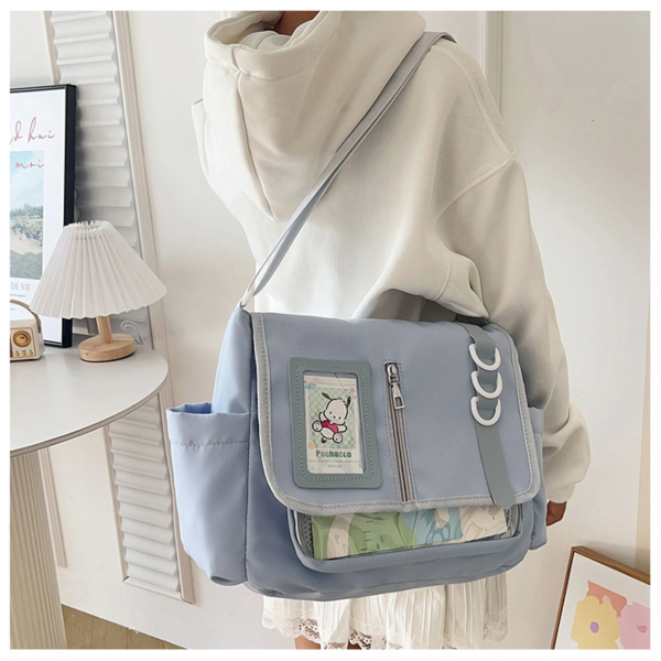 Pastel blue ita bag worn crossbody on a person, showing scale