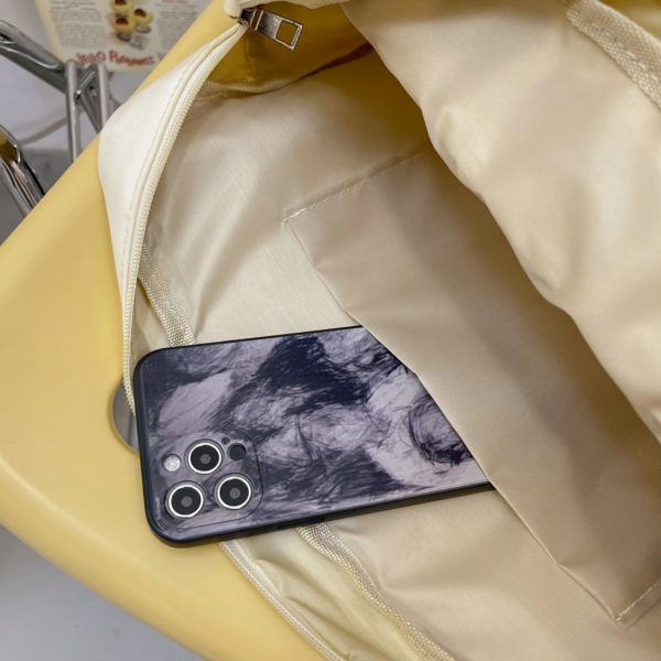 Pastel blue ita bag on table showing phone pocket interior