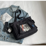Black Ita Bag on Textured Grey Background