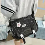 Black Star Ita Bag Worn with Grey Outfit