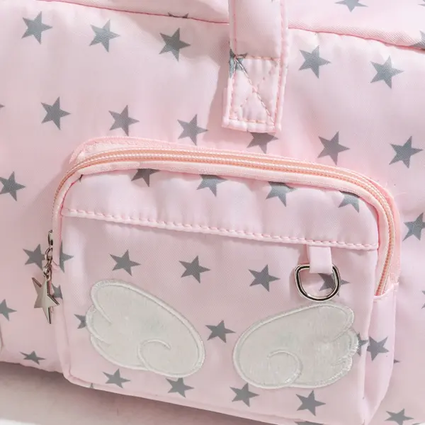 Close up of clear vinyl window with decorative wings on pink star ita bag