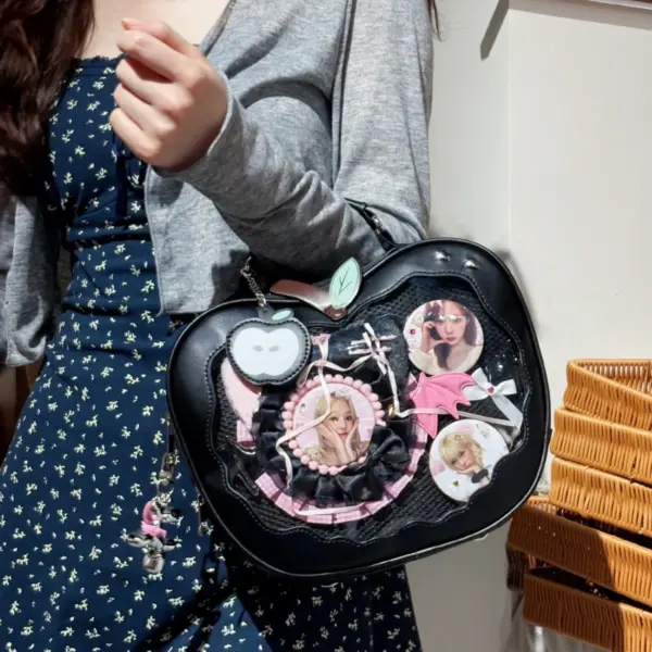 black apple ita bag held by person with character pins on display