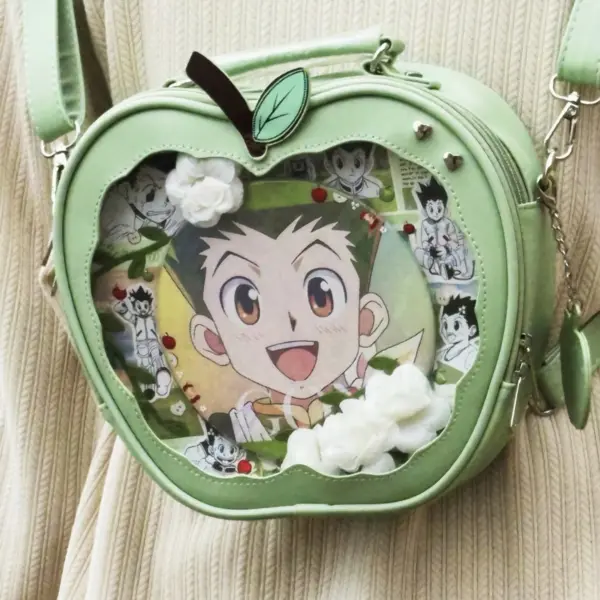 light green apple shaped ita bag with anime character art inside