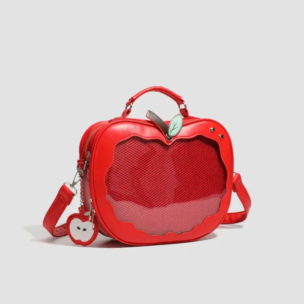 apple shaped ita bag held by person