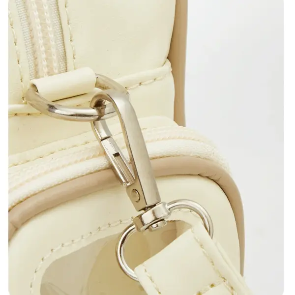 Close-up of star zipper pull and side pocket on white cat ear ita bag