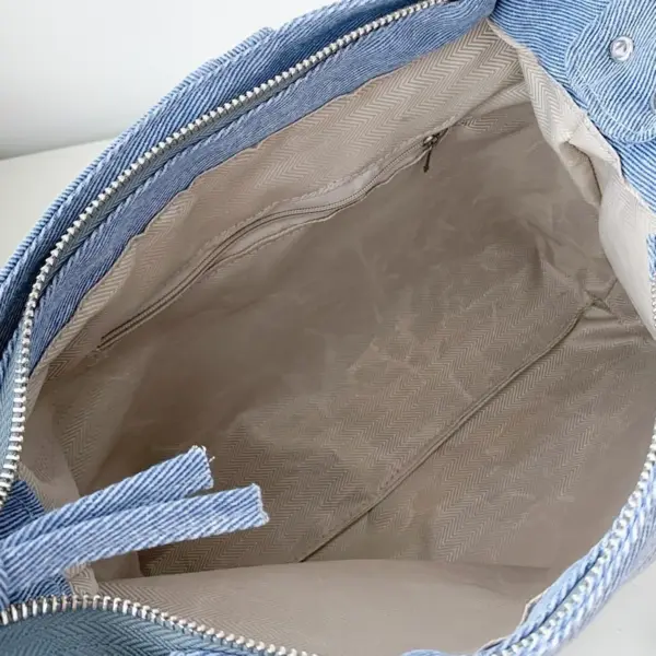 interior view of denim ita bag showing spacious compartment and lining