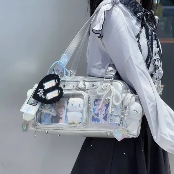 white ita bag with black heart-shaped charm hanging from strap and character cards inside