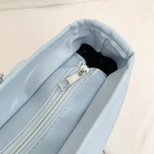 Close-up of interior zipper and pocket inside light blue ita bag