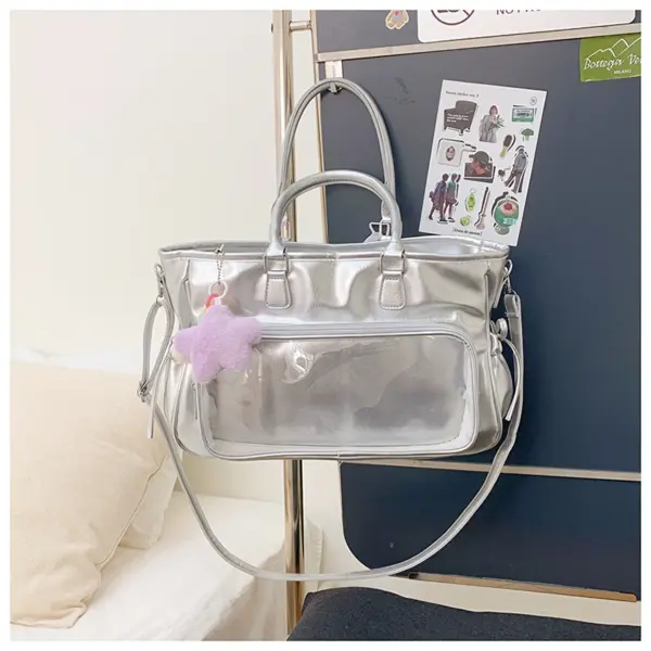 Silver ita bag on stand showing clear window and top handles