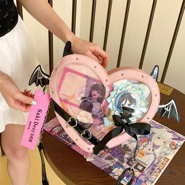 close up of heart shaped ita bag clear window and bat wings