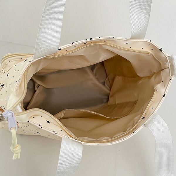 Interior view of the open ita bag showing beige lining and slip pocket