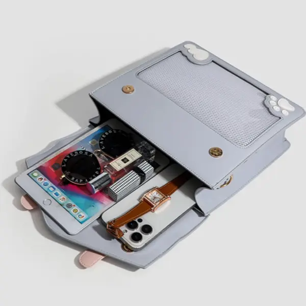 Open ita bag showing interior with notebook, pens, and phone