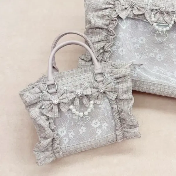 Close-up of pearl bow and lace trim on ita bag