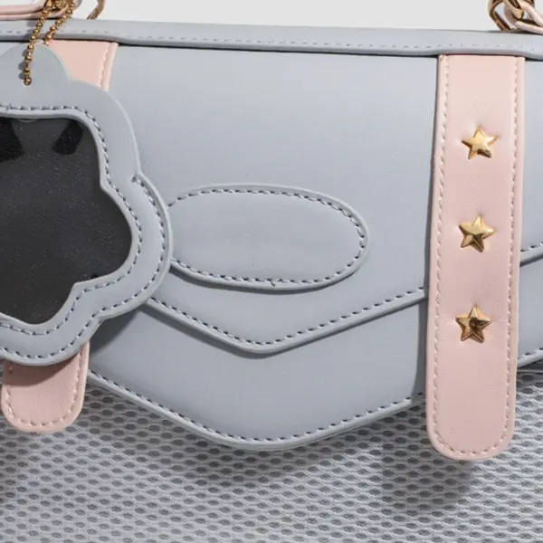Close up of ita bag side showing gold star studs and paw charm