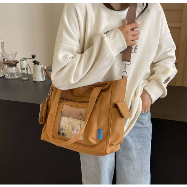 Person wearing black ita bag crossbody