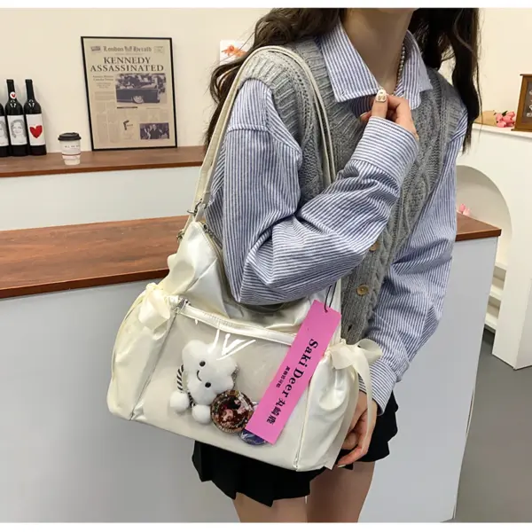 Pink bag held by person with grey vest