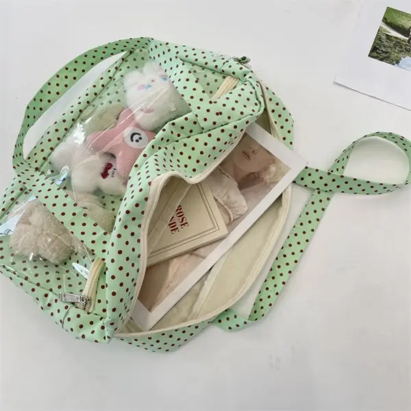 Angled view of mint green polka dot ita bag with magazine inside
