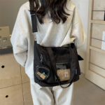 Person Wearing Black Ita Bag Over Shoulder