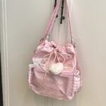 Pink Polka Dot Ita Bag Hanging on White Door