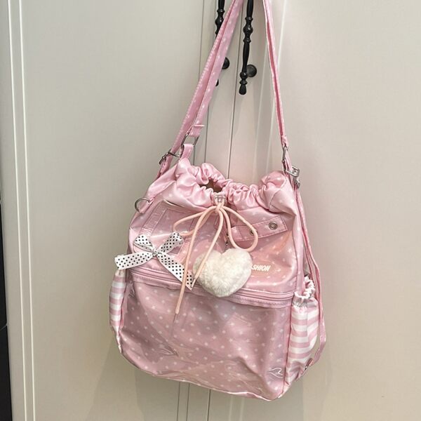 Pink Polka Dot Ita Bag Hanging on White Door