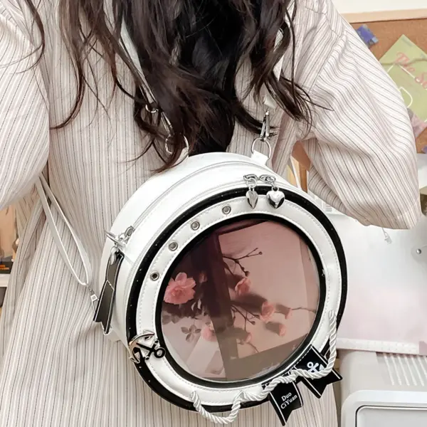 Close up of round ita bag backpack showing transparent window and bow