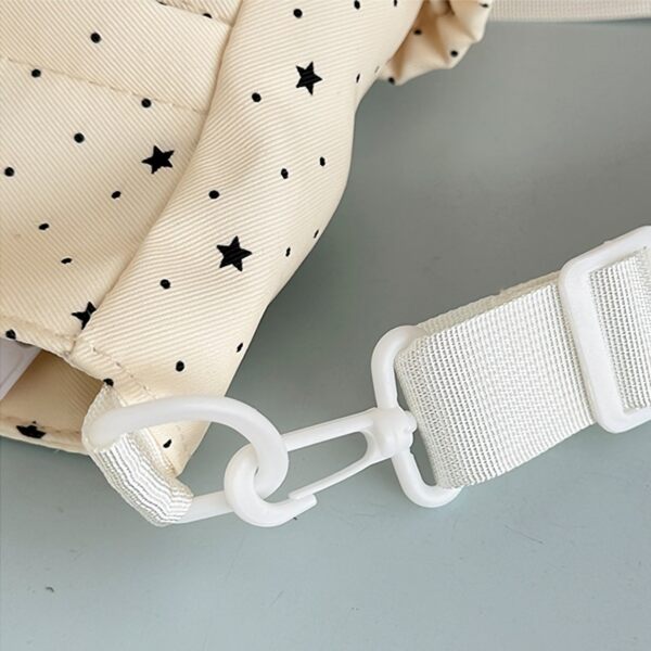 Close up of side strap attachment with white carabiner clip and fabric loop