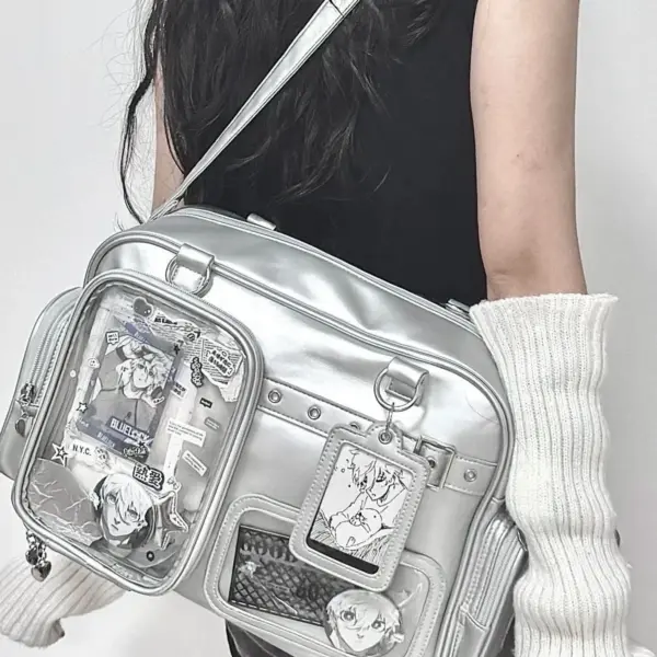 Silver ita bag worn over shoulder with clear display window showing plush and pins