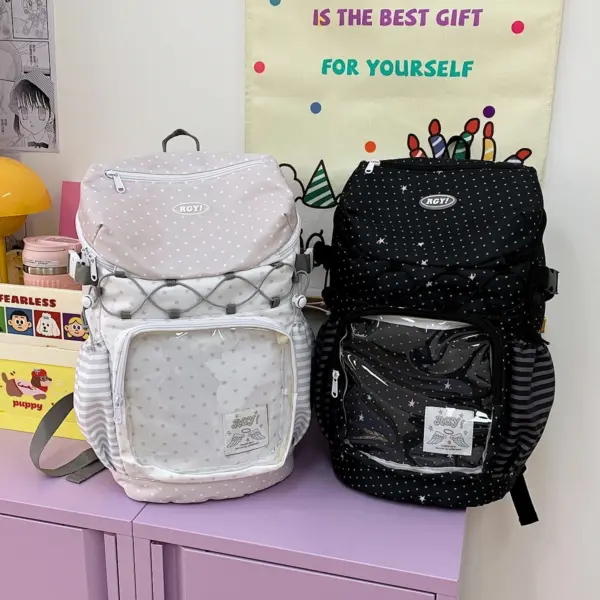 Two ita backpacks sitting on table, gray and pink