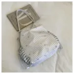 White Polka Dot Ita Bag Flat Lay Next to Notebook