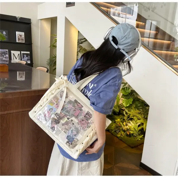person wearing ita bag with plush inside