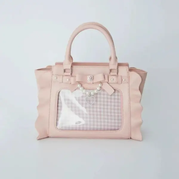 Pink variant of the ruffled ita bag showing side ruffles and clear window