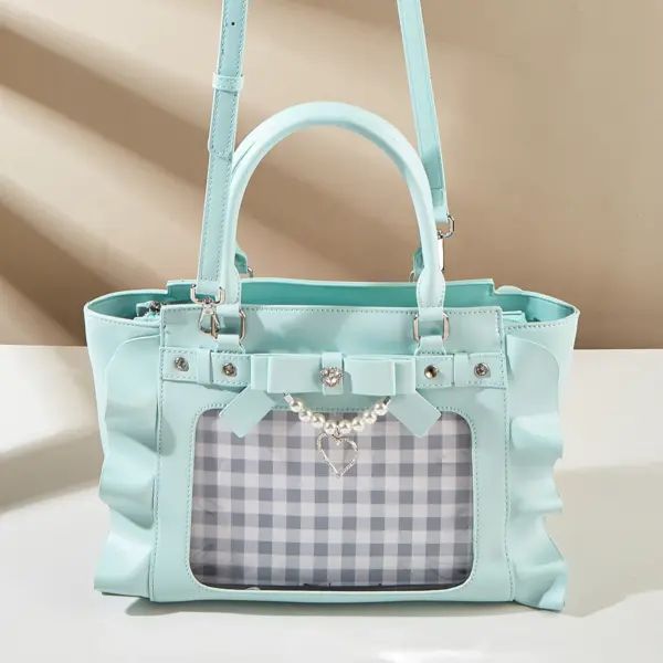 Top view of mint green ita bag showing two handles and pearl strap