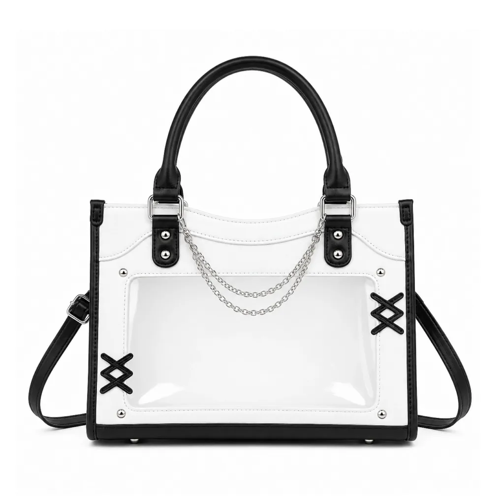 White and black ita bag crossbody with clear front window, adjustable strap, and faux leather finish, ideal for pin display