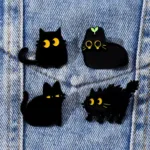 Black Cat Enamel Pins Attached to Denim Black Cat Enamel Pins Attached to Denim