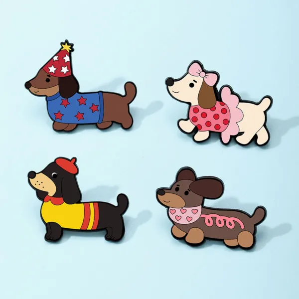 Four dog enamel pins on light blue background