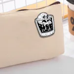 Drink Skull Pin on Light Beige Pouch