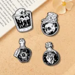 Gothic Enamel Pins Displayed on Book and Flower